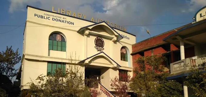 Front of the Library Auditorium at Kakching, with a sign reading “Constructed by Public Donation”.