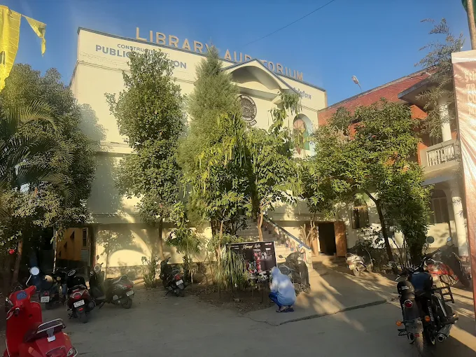 Morning view of the library campus showing the auditorium and the adjoining red building.